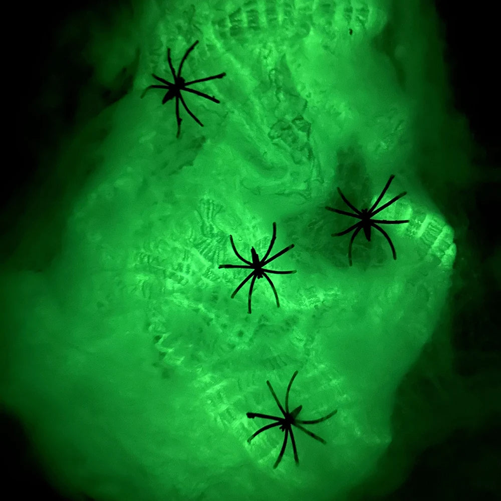 Multiple glow-in-the-dark spider webs for Halloween horror decorations"